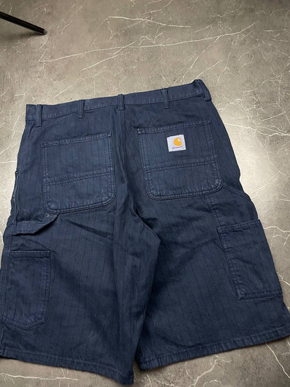 Carhartt navy shorts with pinstripe detail and logo patch on back pocket.