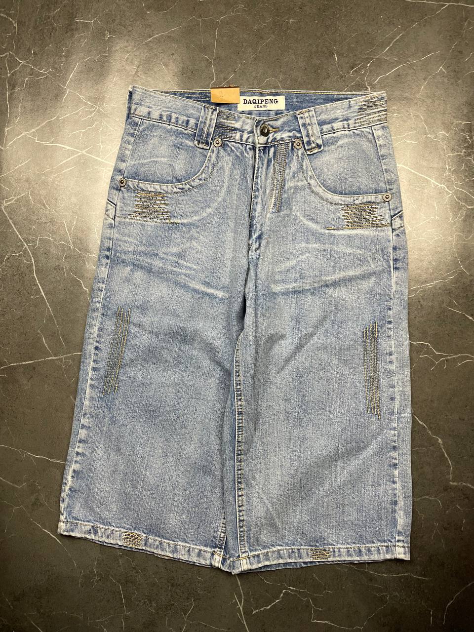 DAQIPENG light blue denim skirt with contrasting black stitching and vintage patch detail.