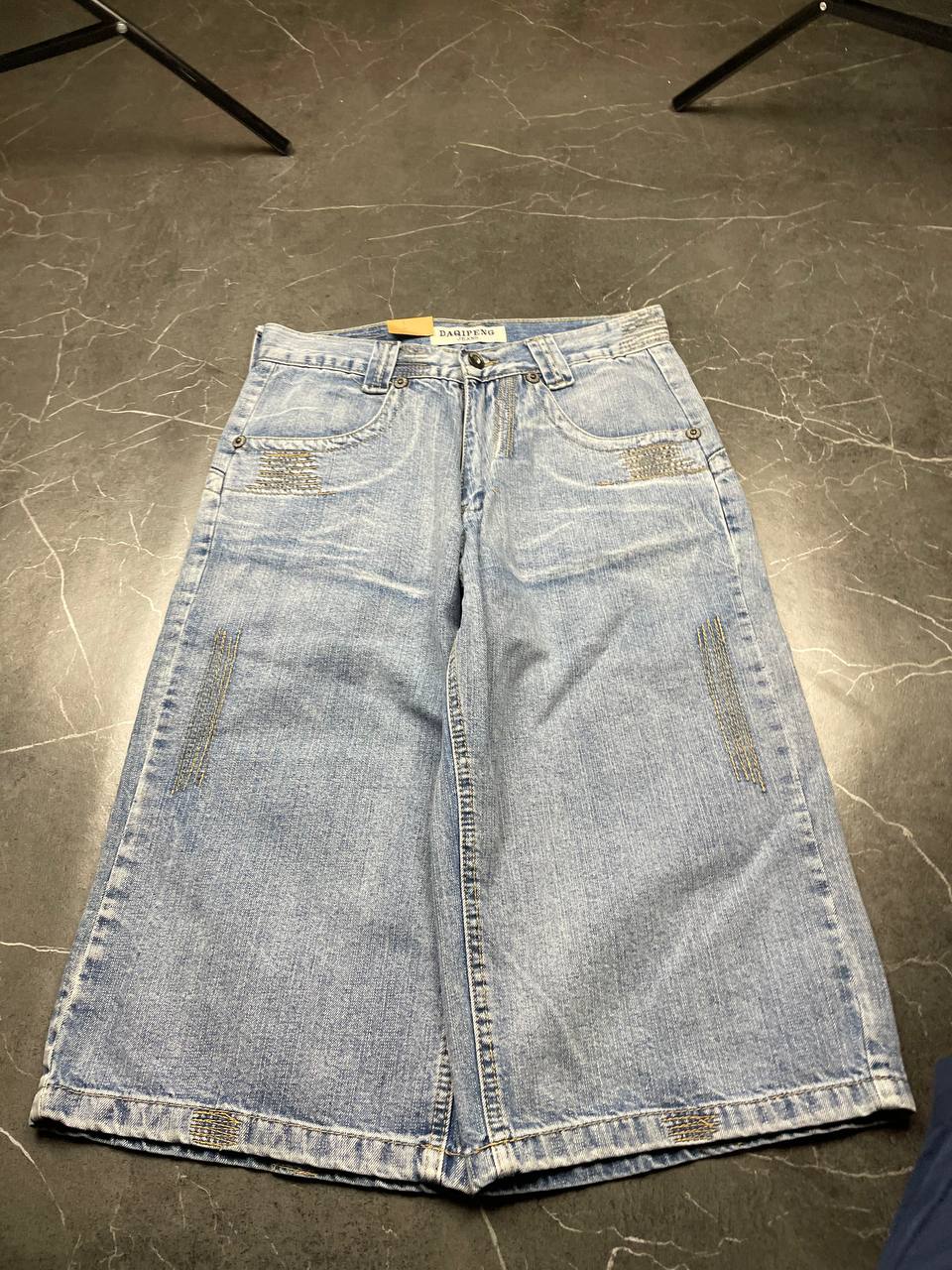 DAQIPENG light blue denim skirt with contrasting black stitching and vintage patch detail.