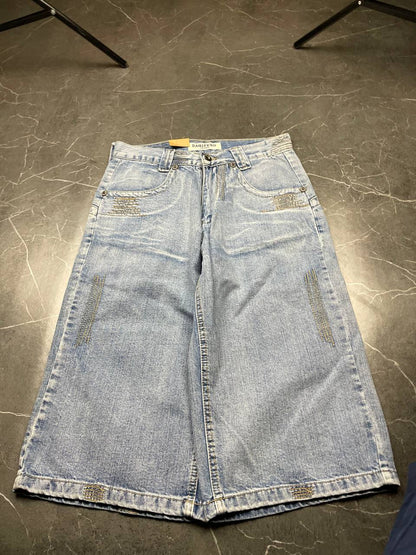 DAQIPENG light blue denim skirt with contrasting black stitching and vintage patch detail.