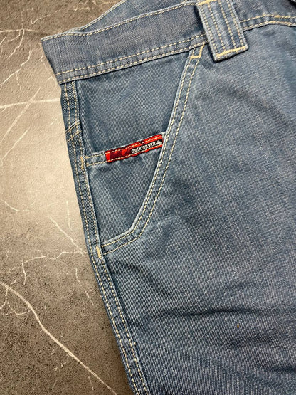 Quiksilver blue denim shorts with yellow contrast stitching and red logo patch.