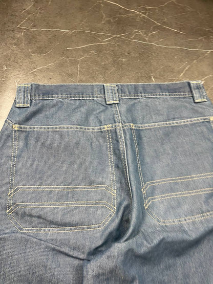 Quiksilver blue denim shorts with yellow contrast stitching and red logo patch.