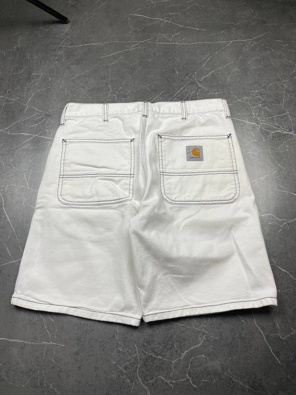 Carhartt white shorts with contrasting black stitching and classic logo patch.