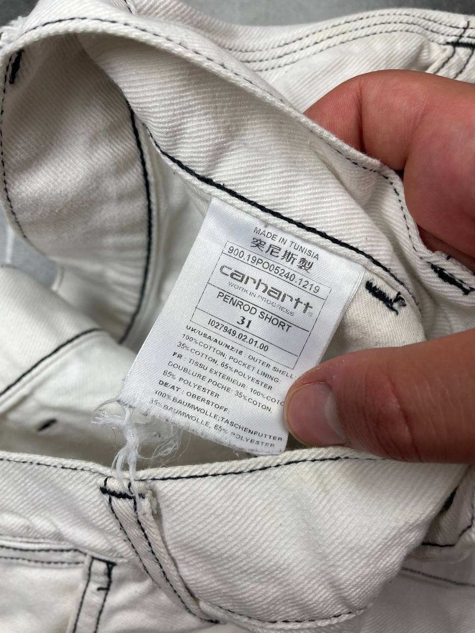 Carhartt white shorts with contrasting black stitching and classic logo patch.