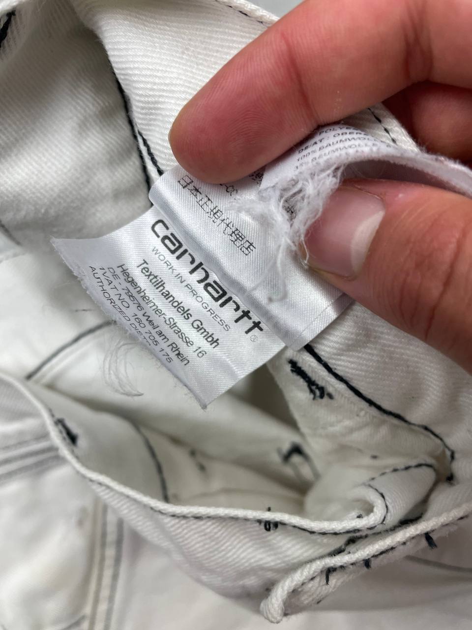 Carhartt white shorts with contrasting black stitching and classic logo patch.