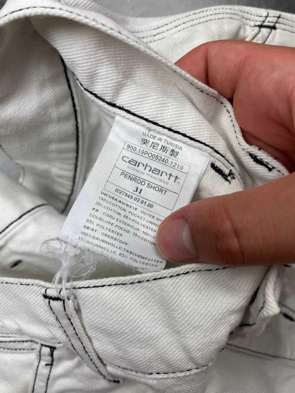 Carhartt white shorts with contrasting black stitching and classic logo patch.