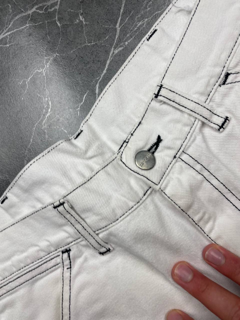 Carhartt white shorts with contrasting black stitching and classic logo patch.