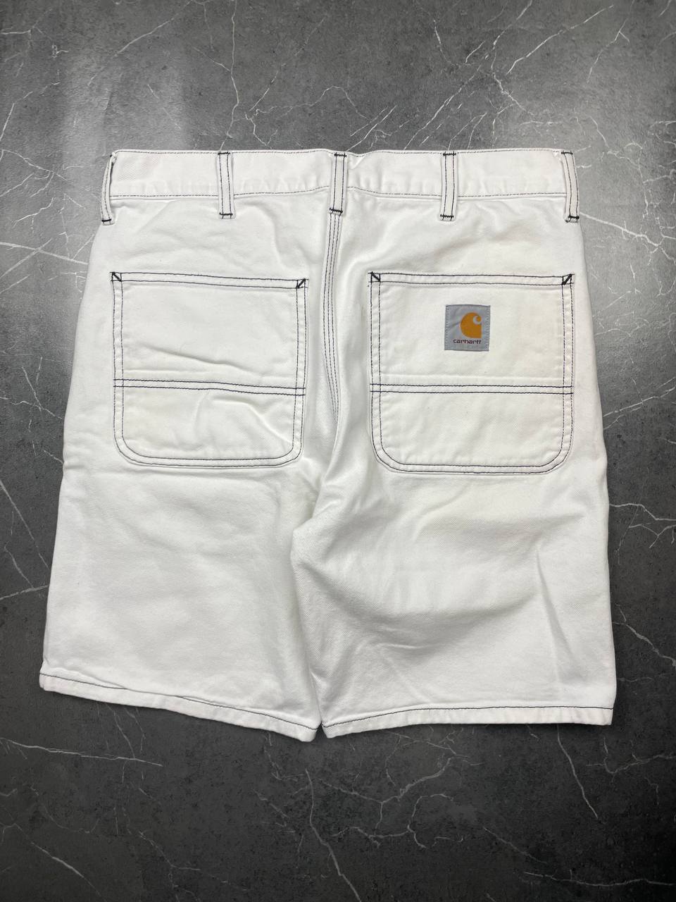 Carhartt white shorts with contrasting black stitching and classic logo patch.