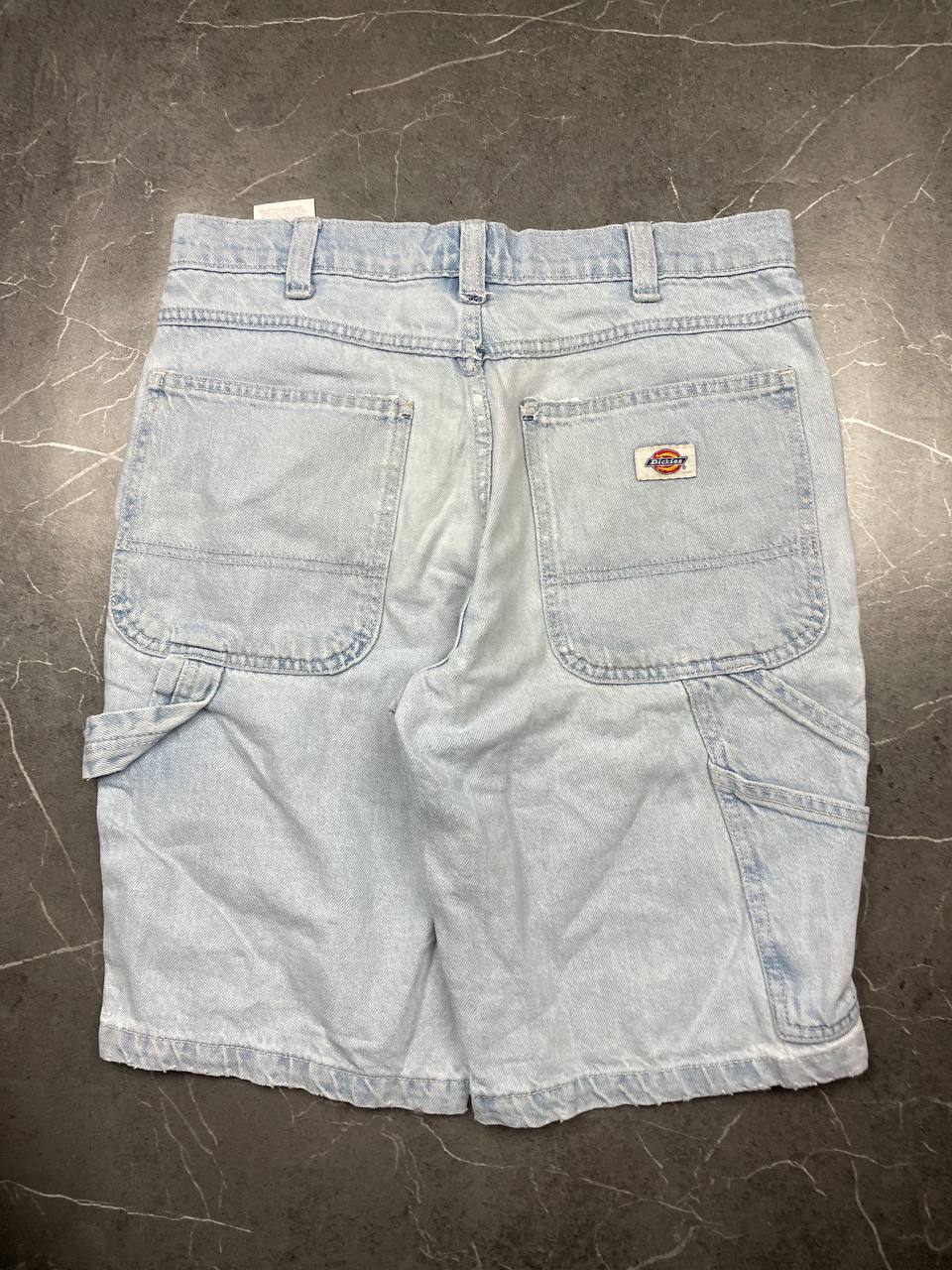 Dickies light blue denim carpenter shorts with logo button, multiple pockets, and hammer loop.