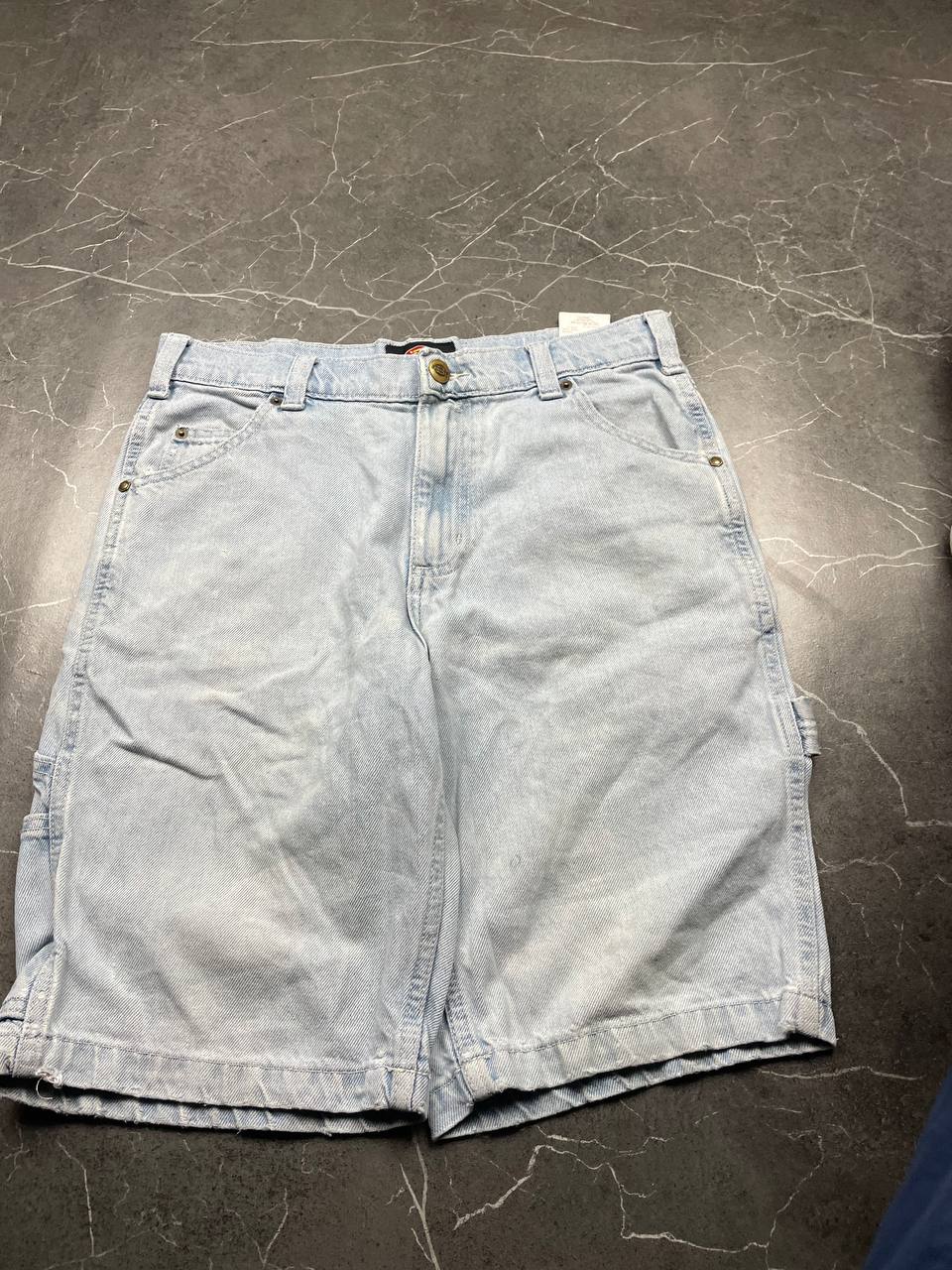 Dickies light blue denim carpenter shorts with logo button, multiple pockets, and hammer loop.