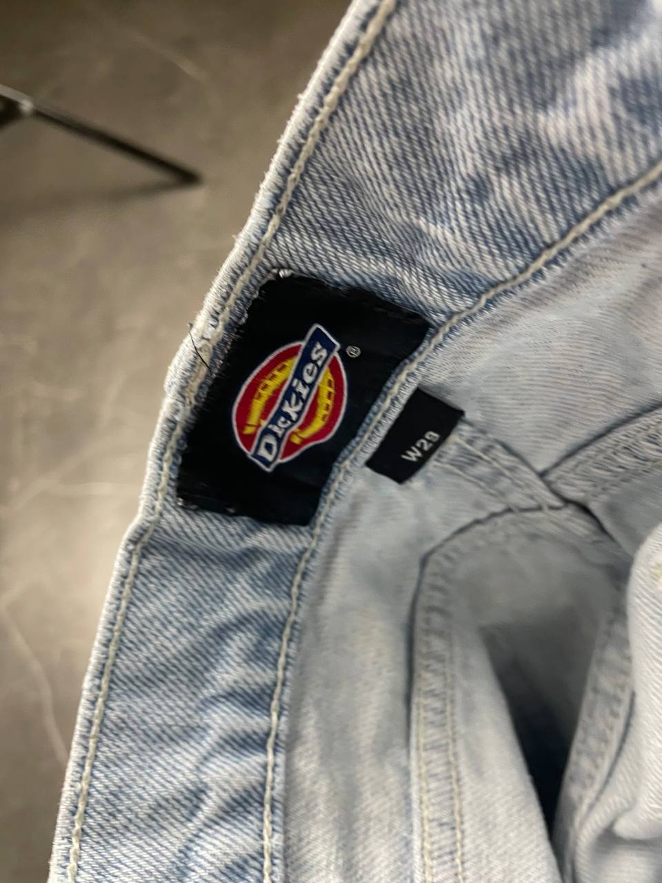 Dickies light blue denim carpenter shorts with logo button, multiple pockets, and hammer loop.