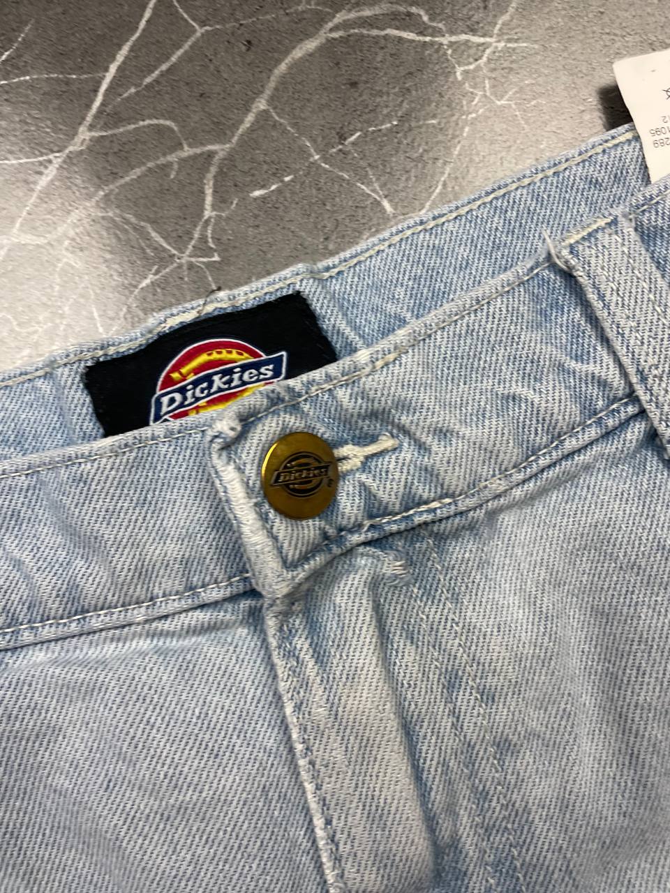 Dickies light blue denim carpenter shorts with logo button, multiple pockets, and hammer loop.