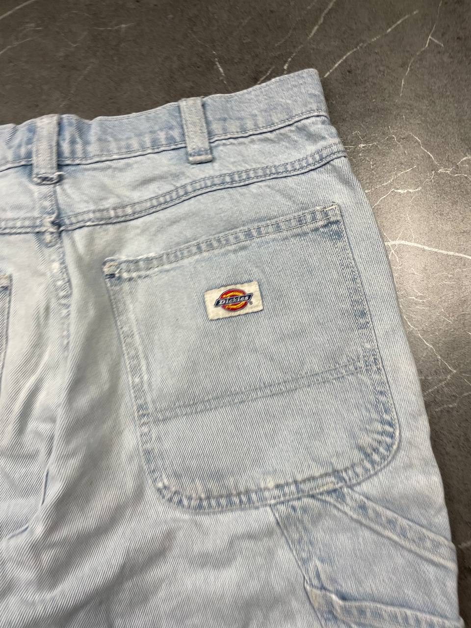 Dickies light blue denim carpenter shorts with logo button, multiple pockets, and hammer loop.