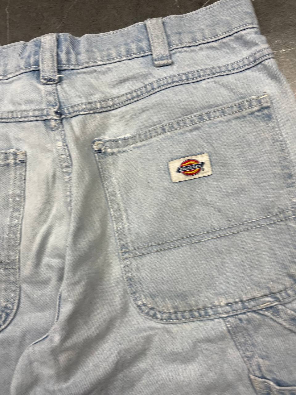 Dickies light blue denim carpenter shorts with logo button, multiple pockets, and hammer loop.