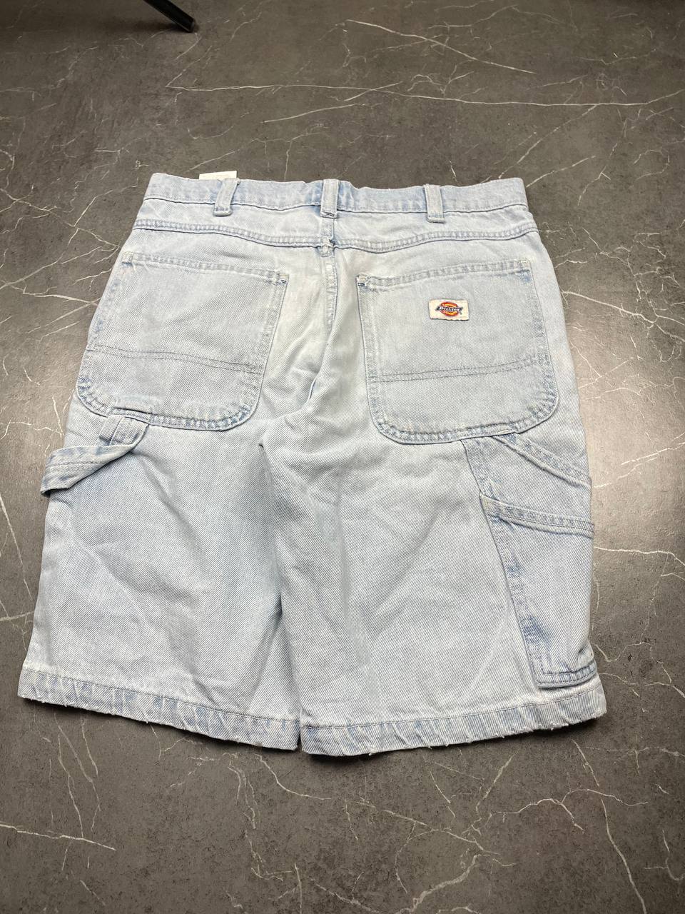 Dickies light blue denim carpenter shorts with logo button, multiple pockets, and hammer loop.