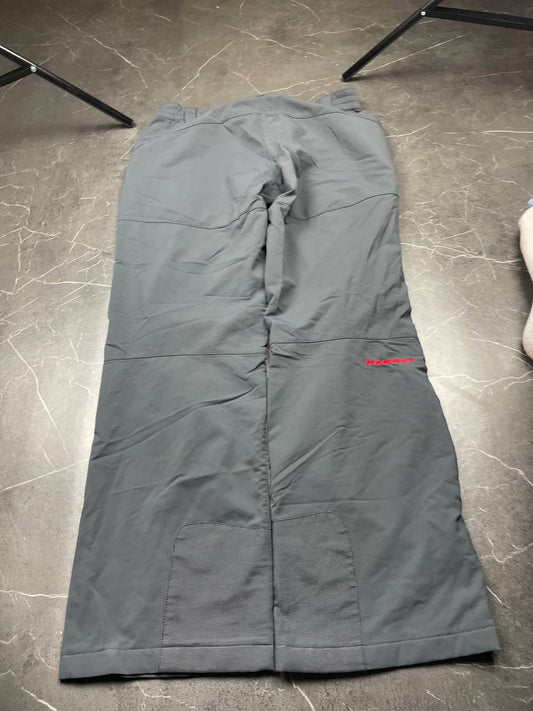 Mammut grey softshell outdoor trousers with reinforced knees, elastic waistband, and zipped pockets.