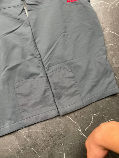 Mammut grey softshell outdoor trousers with reinforced knees, elastic waistband, and zipped pockets.