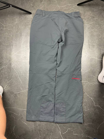 Mammut grey softshell outdoor trousers with reinforced knees, elastic waistband, and zipped pockets.