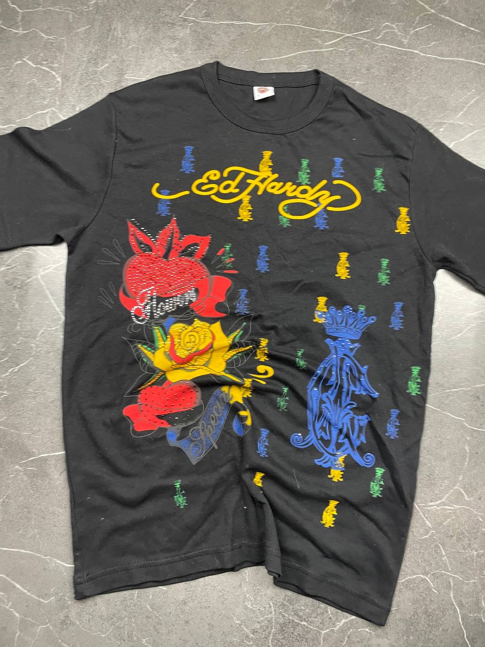 Ed Hardy black graphic t-shirt featuring colorful motifs and signature logo on front.