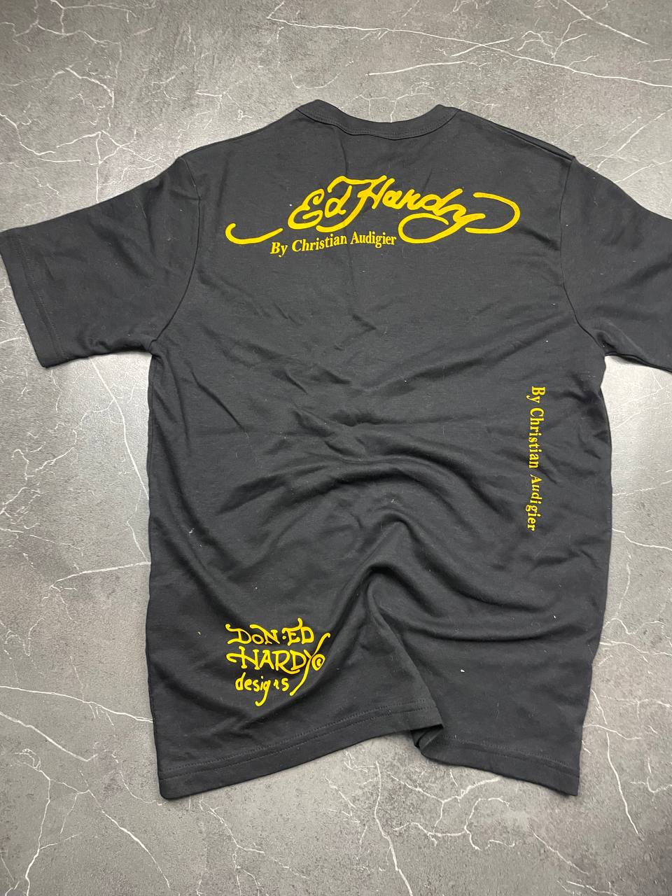 Ed Hardy black graphic t-shirt featuring colorful motifs and signature logo on front.