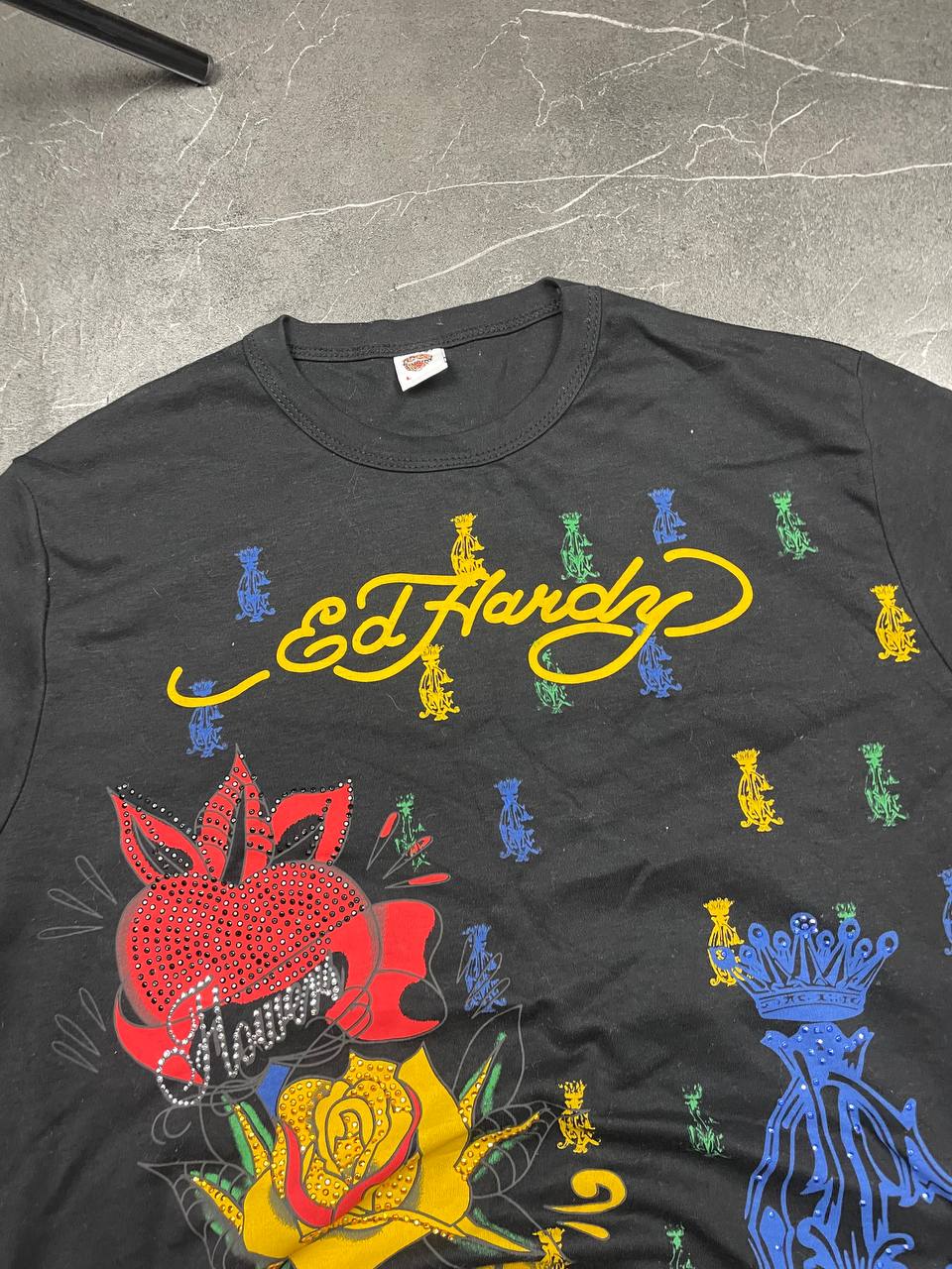 Ed Hardy black graphic t-shirt featuring colorful motifs and signature logo on front.