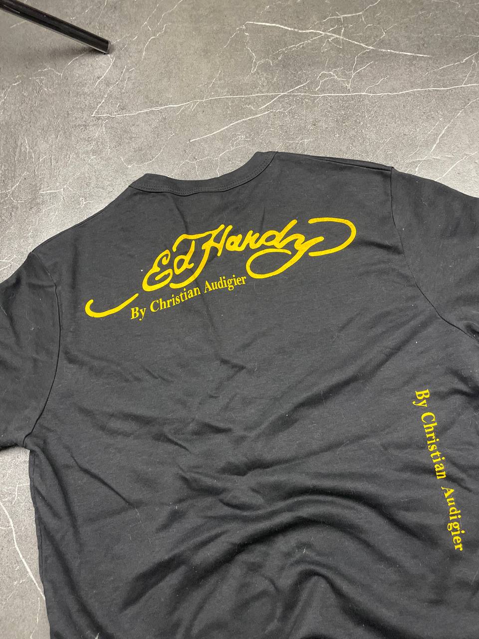 Ed Hardy black graphic t-shirt featuring colorful motifs and signature logo on front.