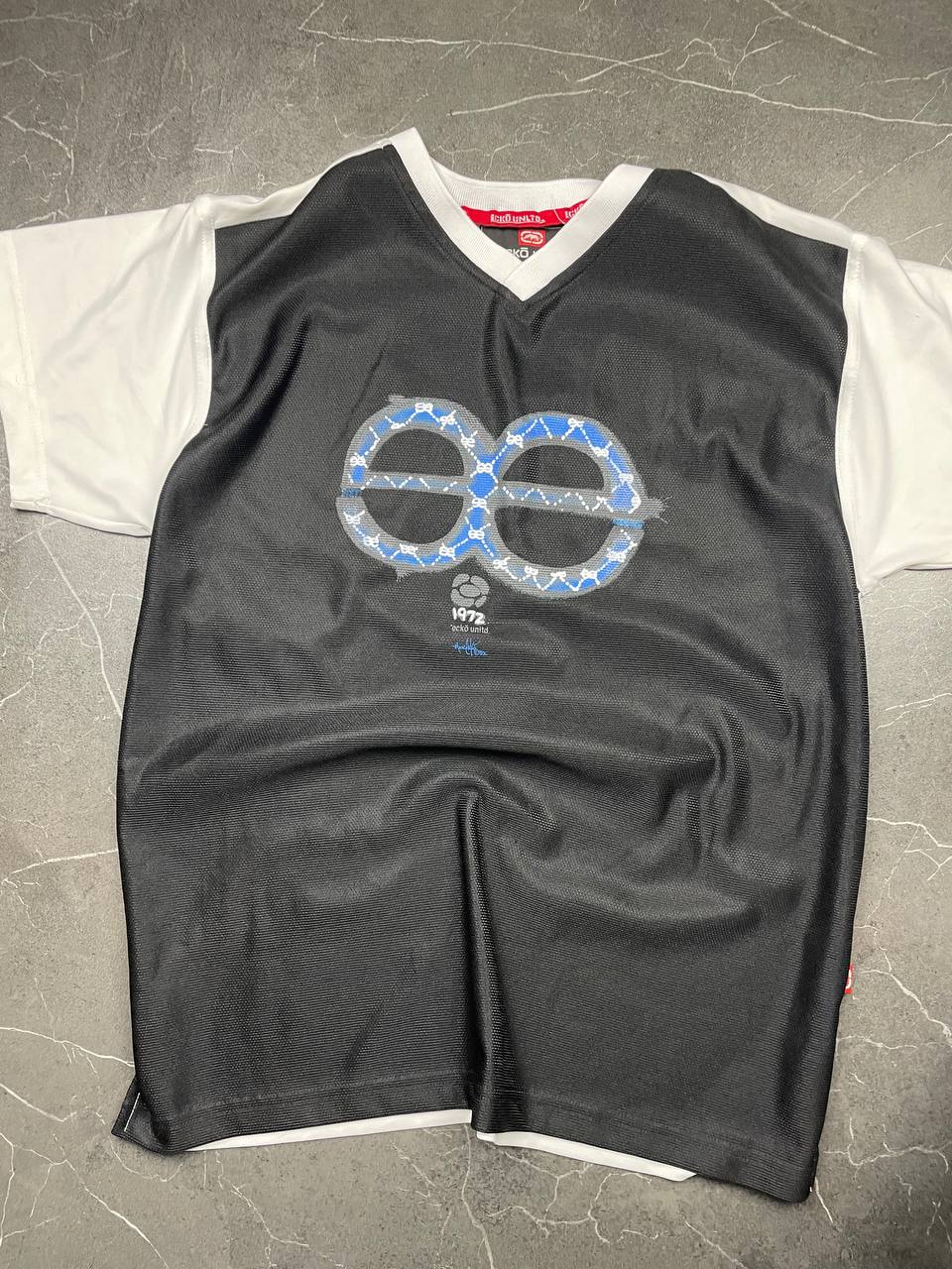 Ecko Unltd black vintage graphic t-shirt with white V-neck collar and blue face design.