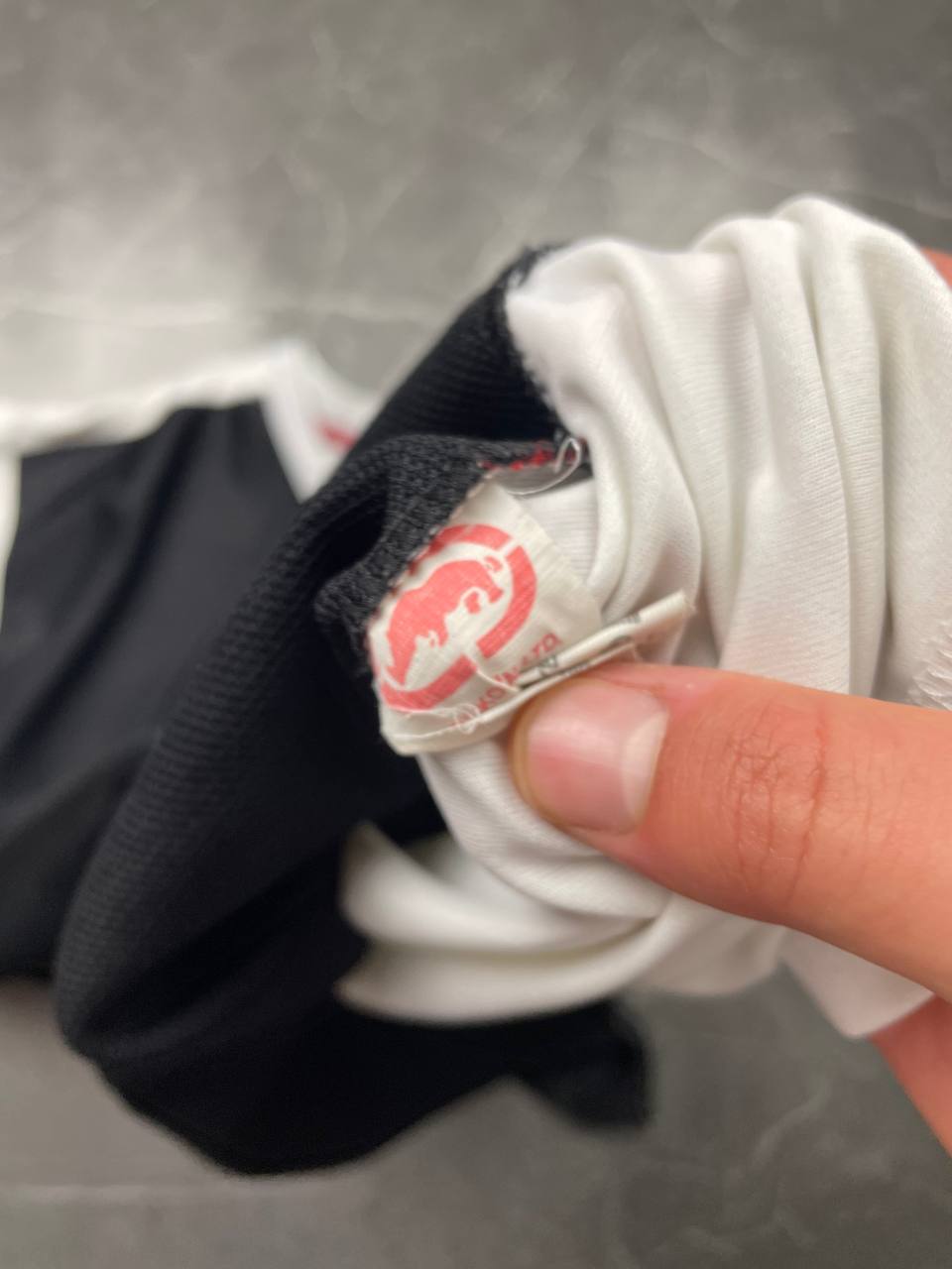 Ecko Unltd black vintage graphic t-shirt with white V-neck collar and blue face design.