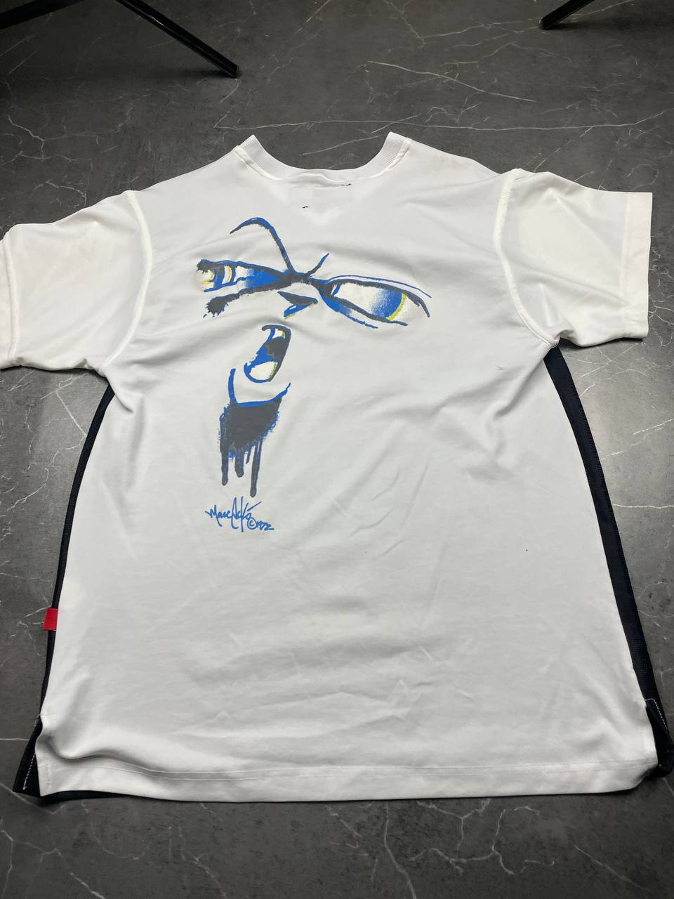 Ecko Unltd black vintage graphic t-shirt with white V-neck collar and blue face design.