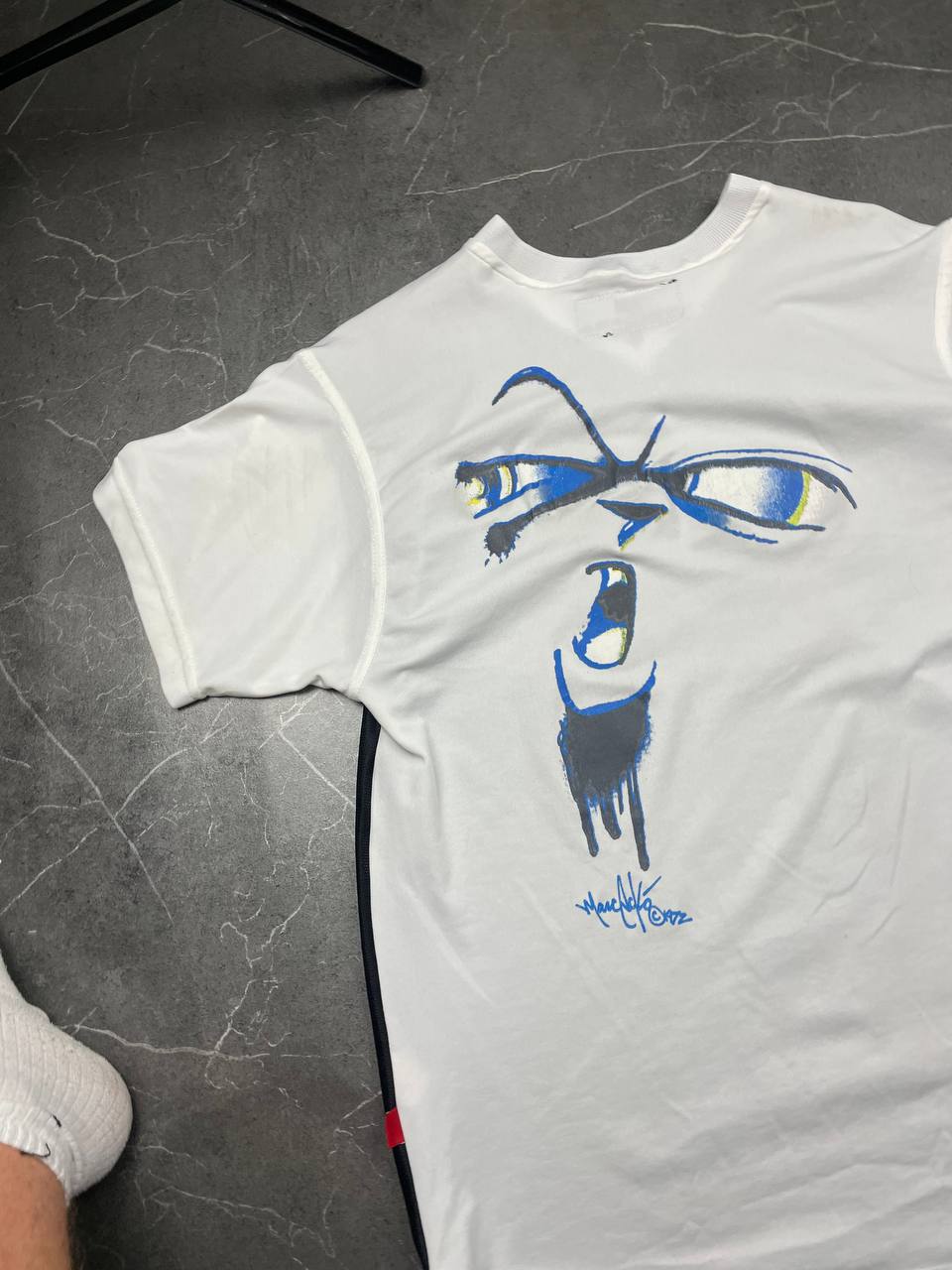 Ecko Unltd black vintage graphic t-shirt with white V-neck collar and blue face design.