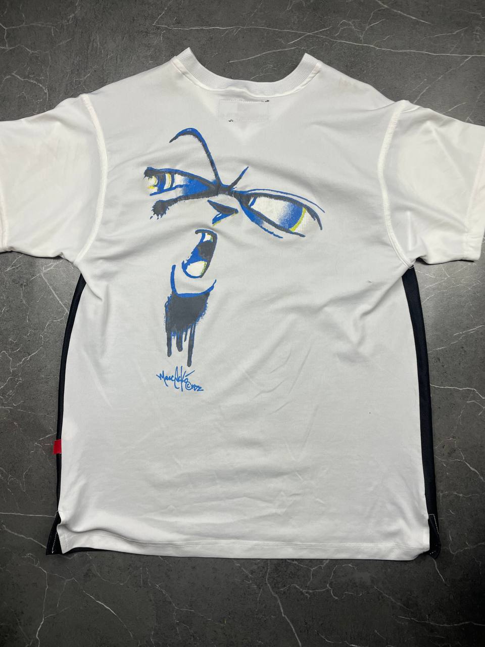 Ecko Unltd black vintage graphic t-shirt with white V-neck collar and blue face design.