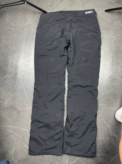 Nike black ACG outdoor pants, waterproof nylon, zip and button closure, zipped side pockets.