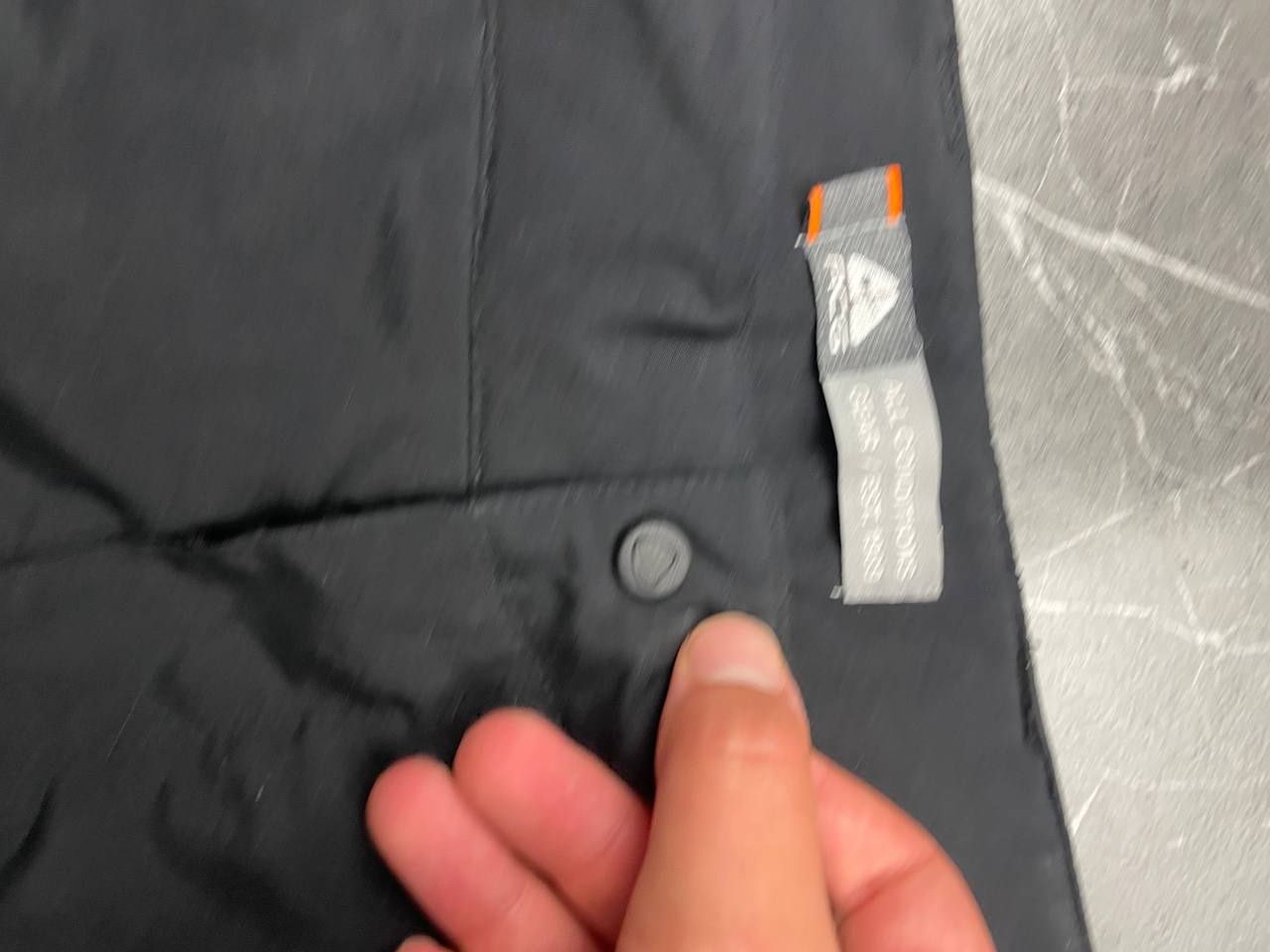 Nike black ACG outdoor pants, waterproof nylon, zip and button closure, zipped side pockets.