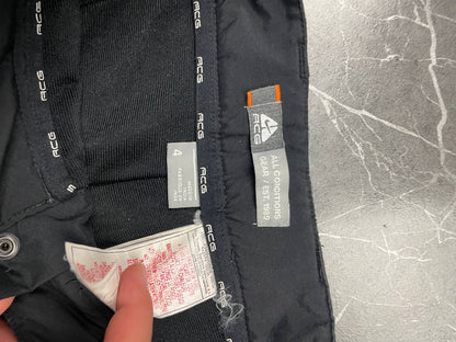 Nike black ACG outdoor pants, waterproof nylon, zip and button closure, zipped side pockets.