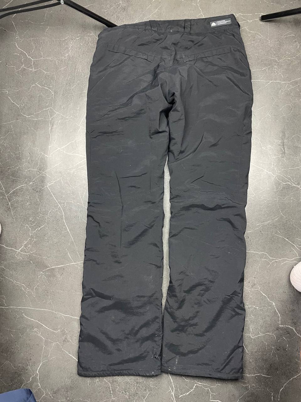 Nike black ACG outdoor pants, waterproof nylon, zip and button closure, zipped side pockets.