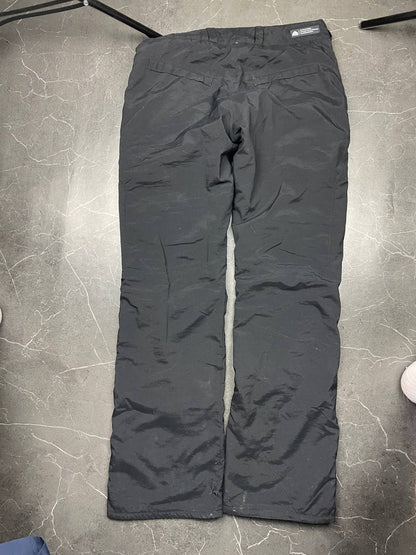 Nike black ACG outdoor pants, waterproof nylon, zip and button closure, zipped side pockets.