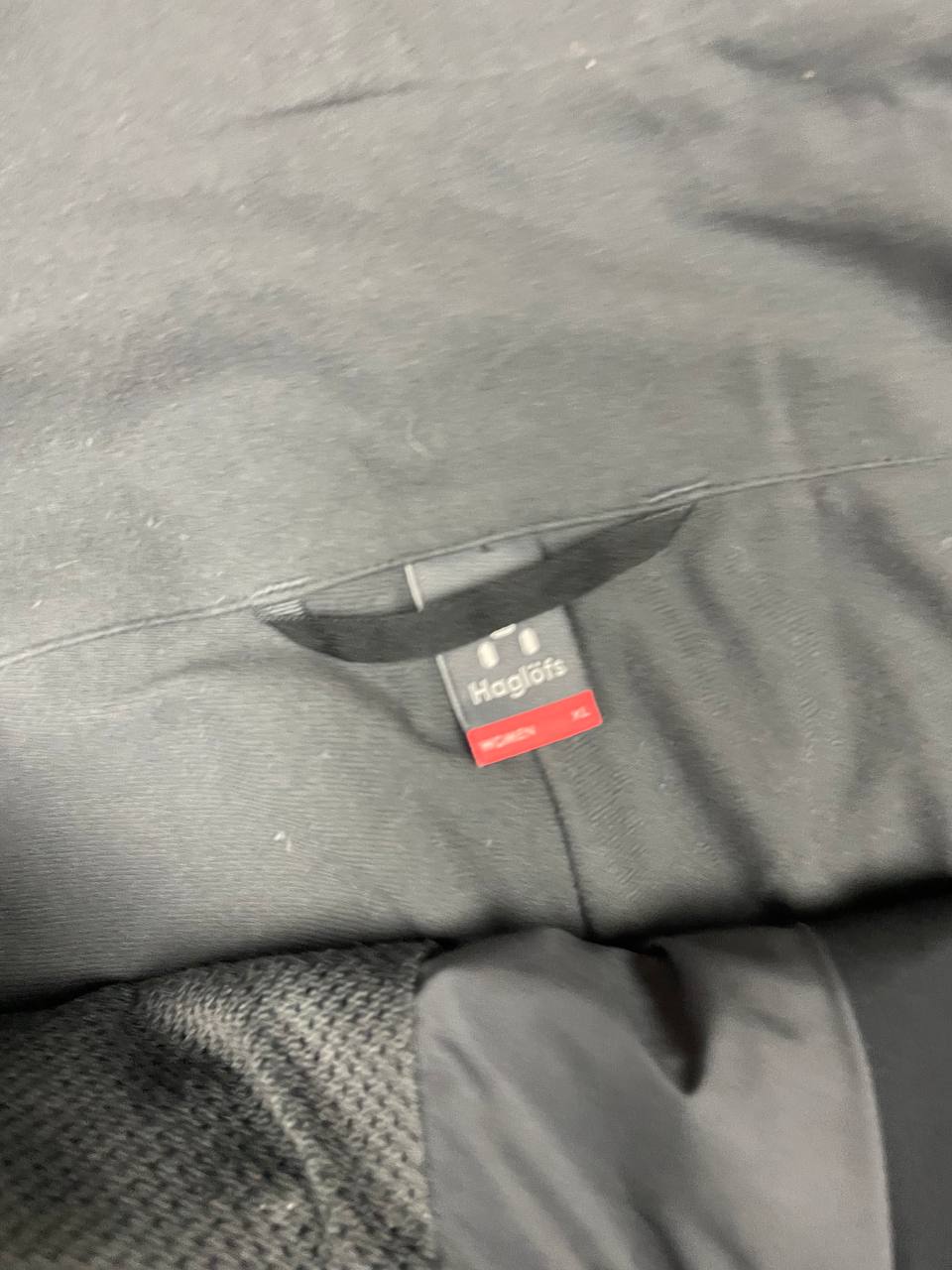 Haglöfs black softshell outdoor trousers with zipped pockets and adjustable Velcro waist tabs.