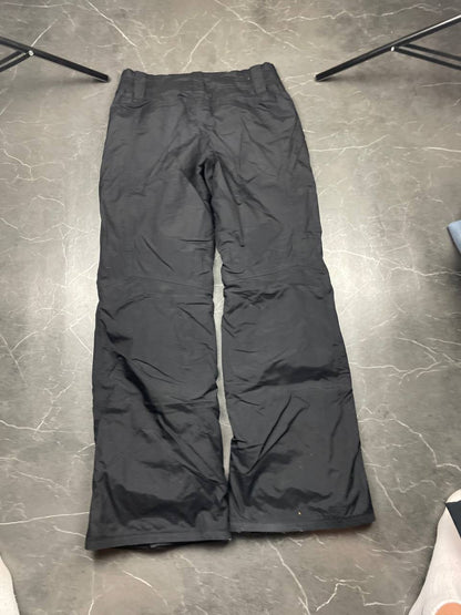 Nike black ski trousers with ACG branding, button closure, and elasticated waistband.