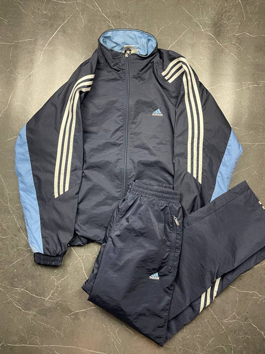 Adidas girls tracksuit navy blue with white stripes, full zip jacket and elastic pants.