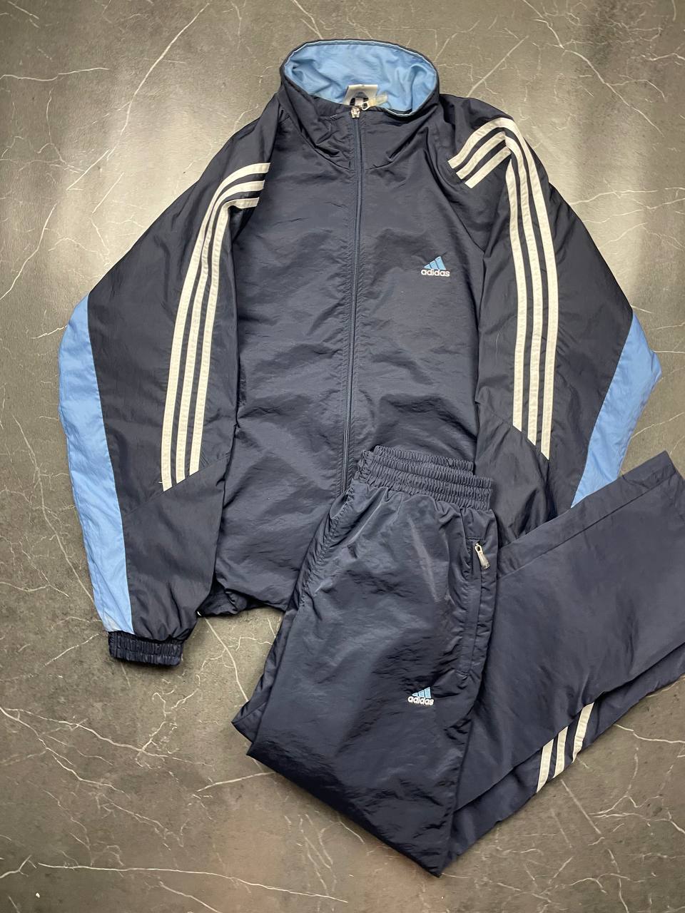 Adidas girls tracksuit navy blue with white stripes, full zip jacket and elastic pants.