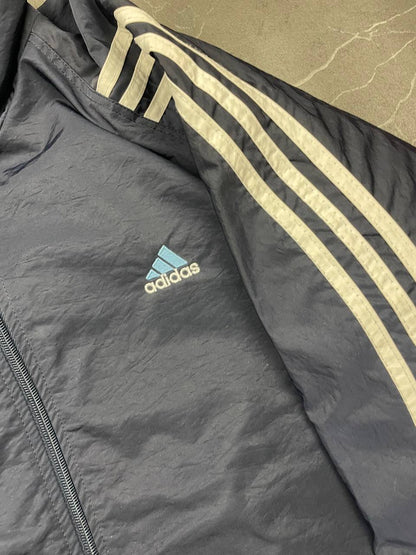 Adidas girls tracksuit navy blue with white stripes, full zip jacket and elastic pants.