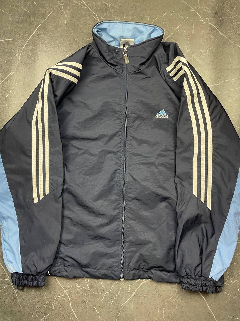 Adidas girls tracksuit navy blue with white stripes, full zip jacket and elastic pants.