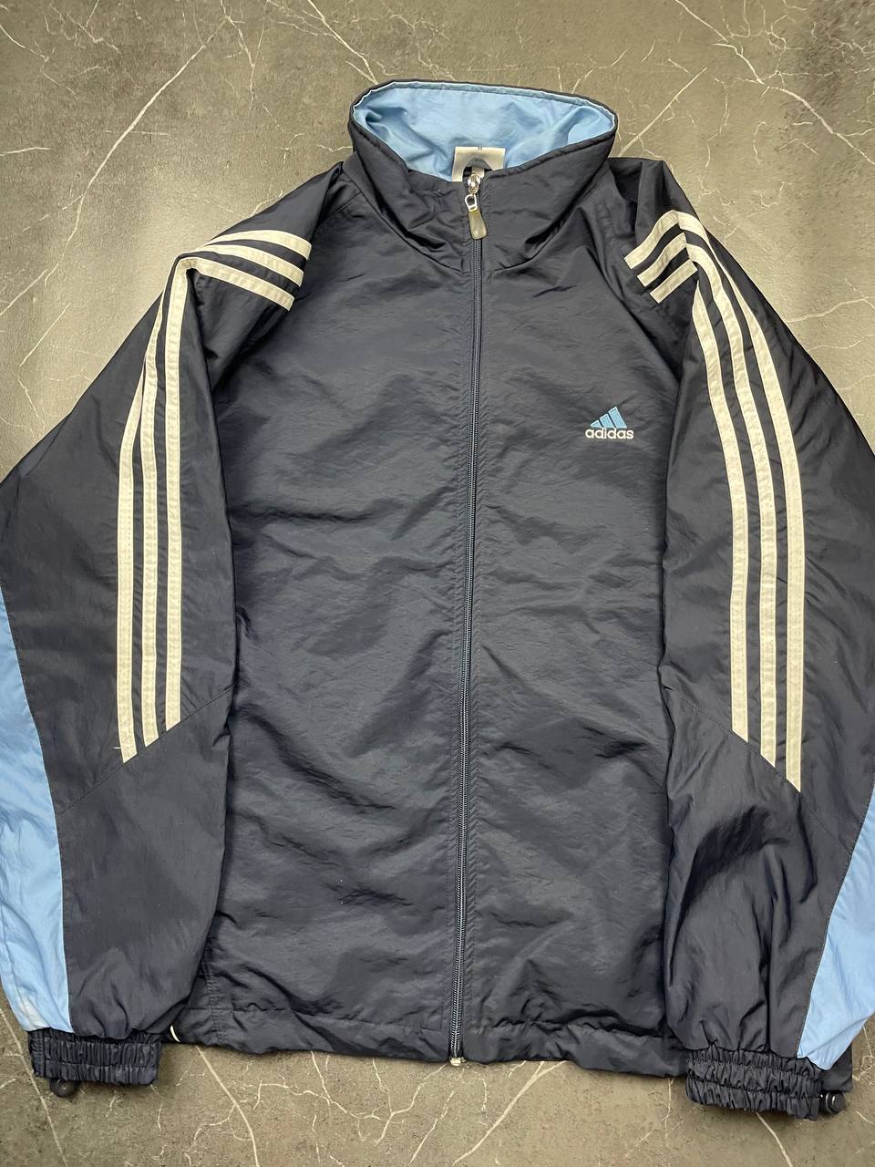 Adidas girls tracksuit navy blue with white stripes, full zip jacket and elastic pants.