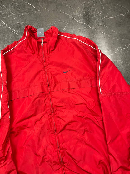 Nike red tracksuit jacket with white piping and navy pants with red trim.