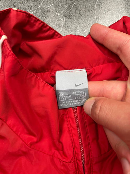 Nike red tracksuit jacket with white piping and navy pants with red trim.