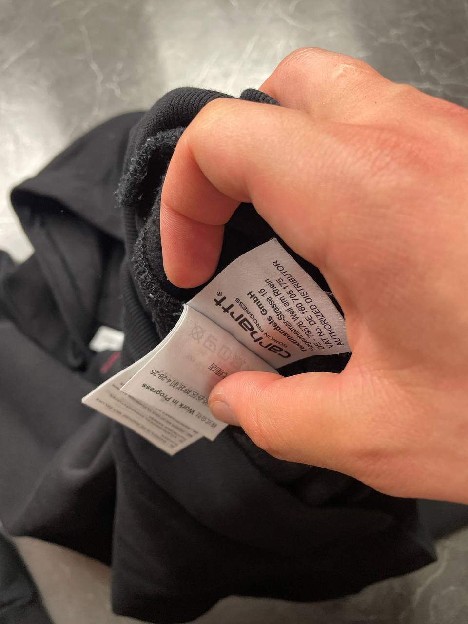 Carhartt black hooded sweatshirt small embroidered logo and front kangaroo pocket.