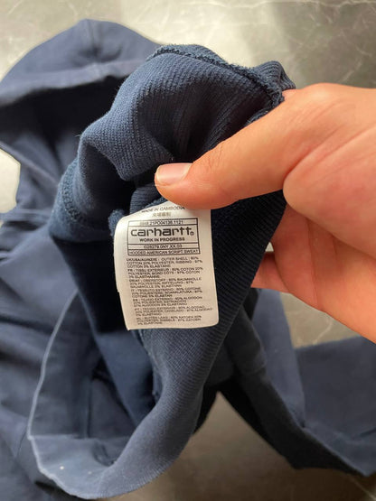 Carhartt navy hooded sweatshirt with American script logo on front left chest.