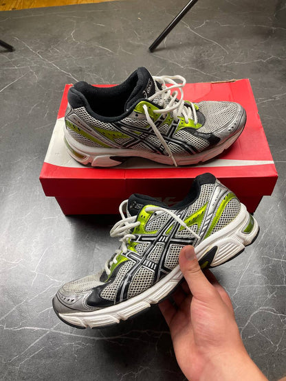ASICS running shoes black white lime green synthetic upper rubber sole with visible wear