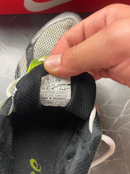 ASICS running shoes black white lime green synthetic upper rubber sole with visible wear