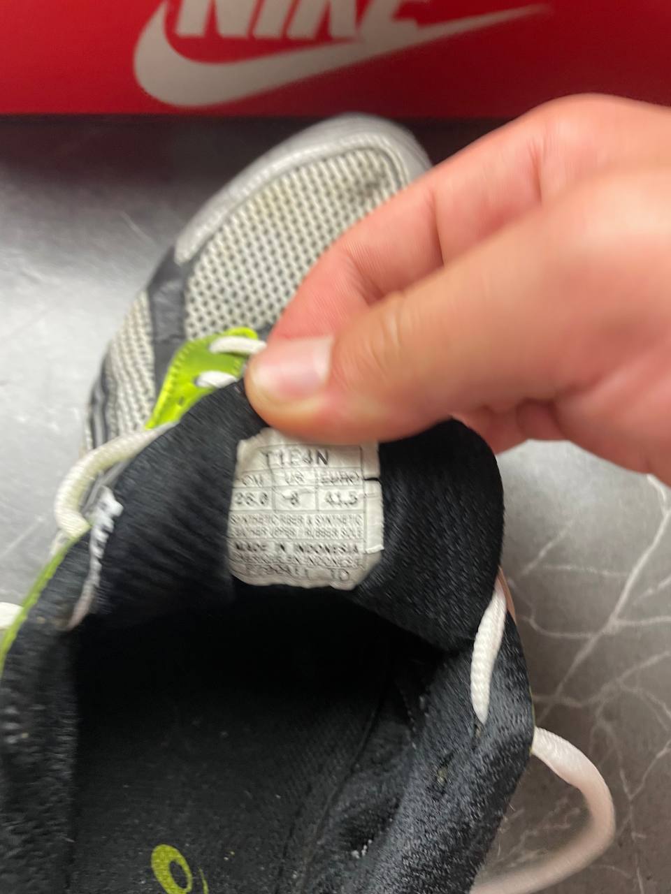 ASICS running shoes black white lime green synthetic upper rubber sole with visible wear